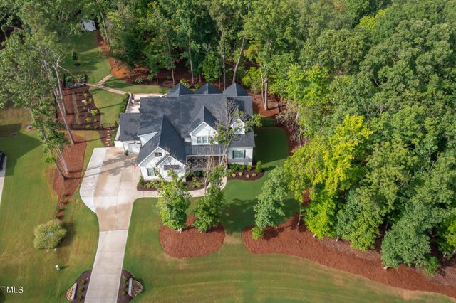 an aerial view of a house with yard swimming pool and outdoor seating