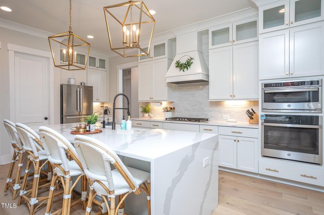 a kitchen with stainless steel appliances granite countertop a sink and stove top oven