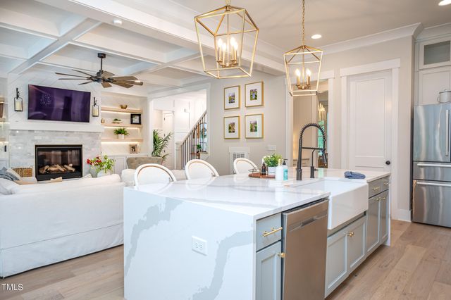 a kitchen with stainless steel appliances kitchen island granite countertop a sink cabinets a counter top space and stainless steel appliances