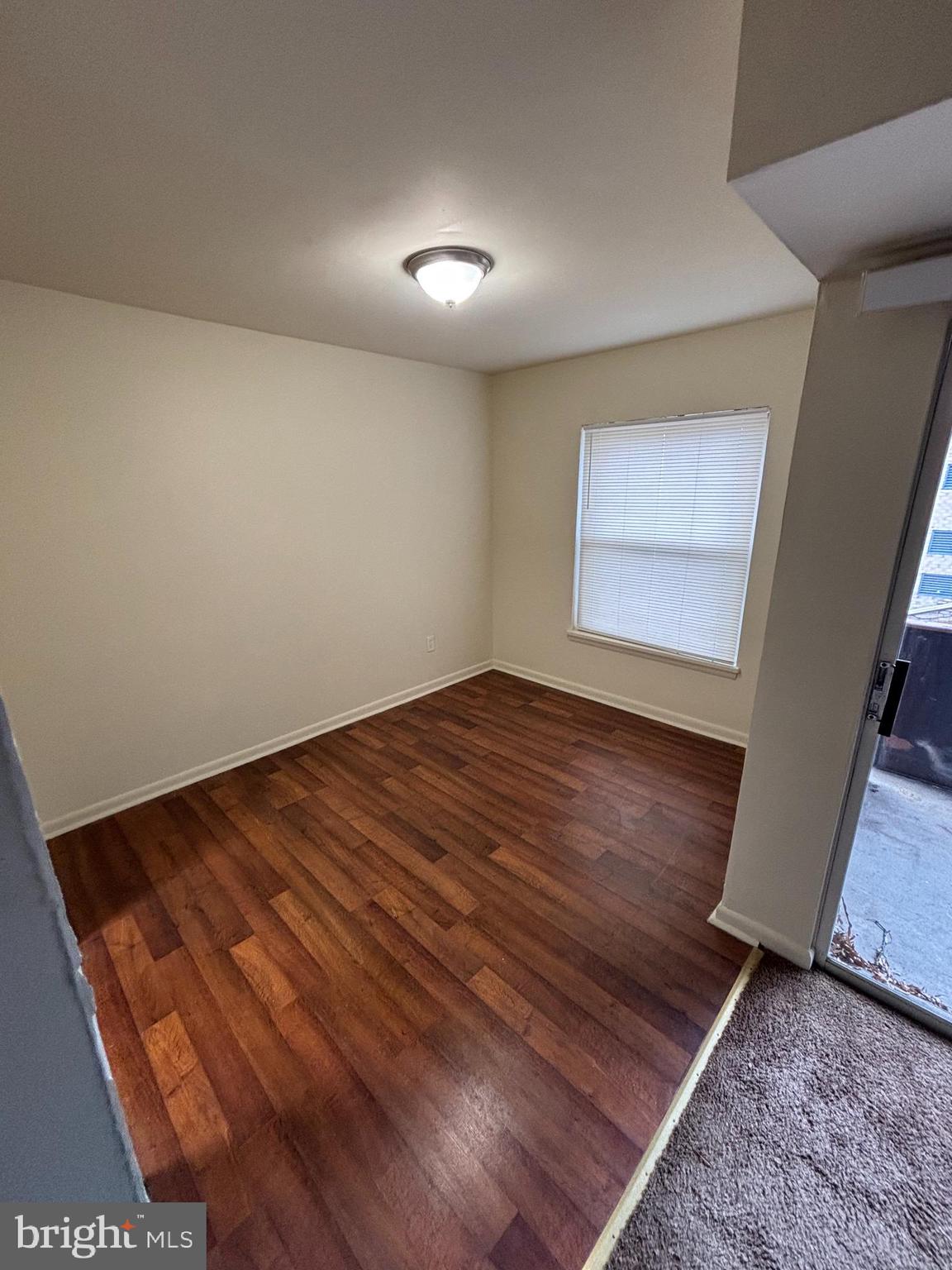 3827 St Barnabas Road, Unit T 103 Suitland, MD 20746 - Photo 3 of 15 an empty room with wooden floor and entrance