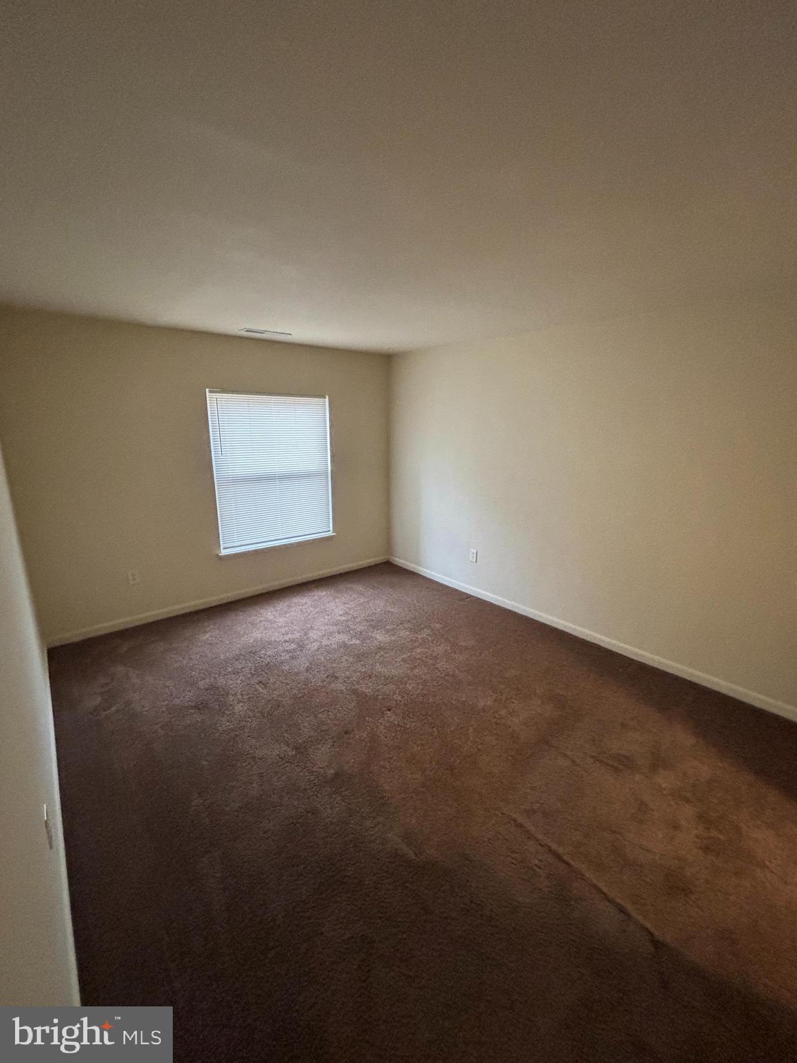 3827 St Barnabas Road, Unit T 103 Suitland, MD 20746 - Photo 9 of 15 a view of an empty room and window