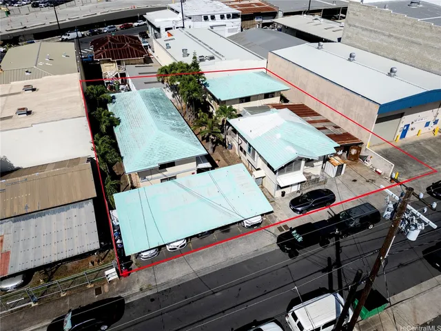 an aerial view of a building with parking area