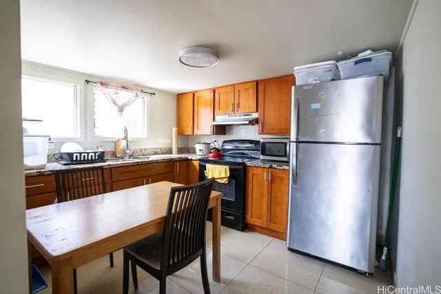 a view of kitchen with refrigerator and cabinets