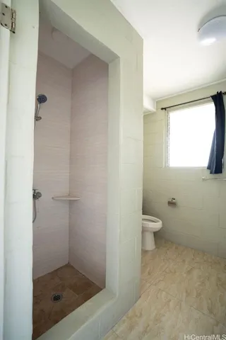 a bathroom with a toilet sink vanity and mirror