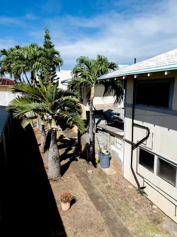 a front view of a building with a tree