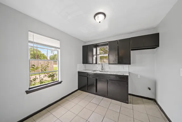 a spacious bathroom with a granite countertop sink and mirror