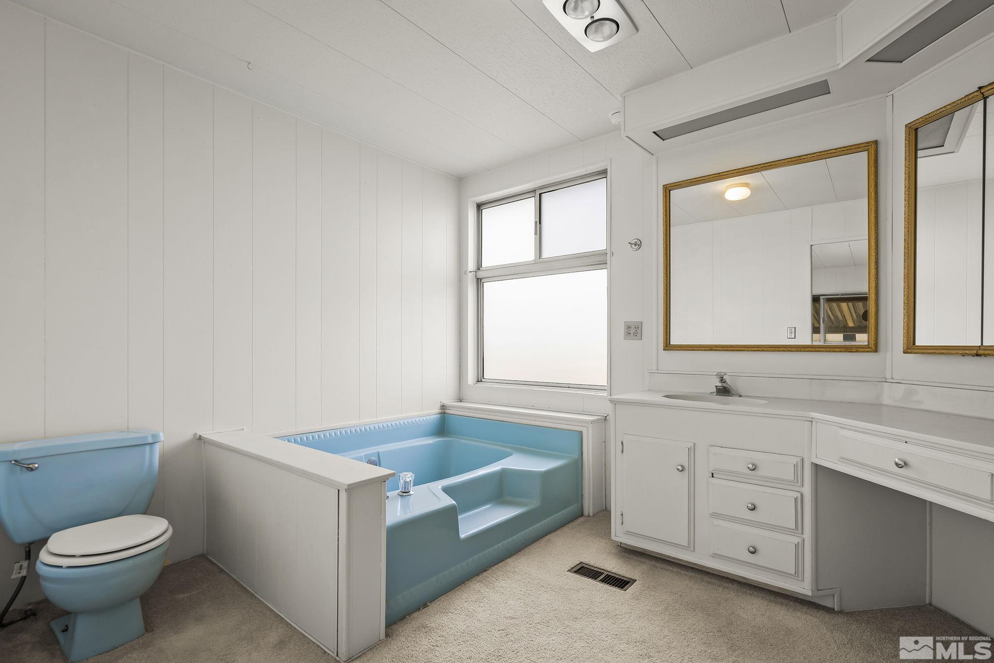16305 Rhyolite Circle Reno, NV 89521 - Photo 12 of 16 a bathroom with a sink a toilet and a window