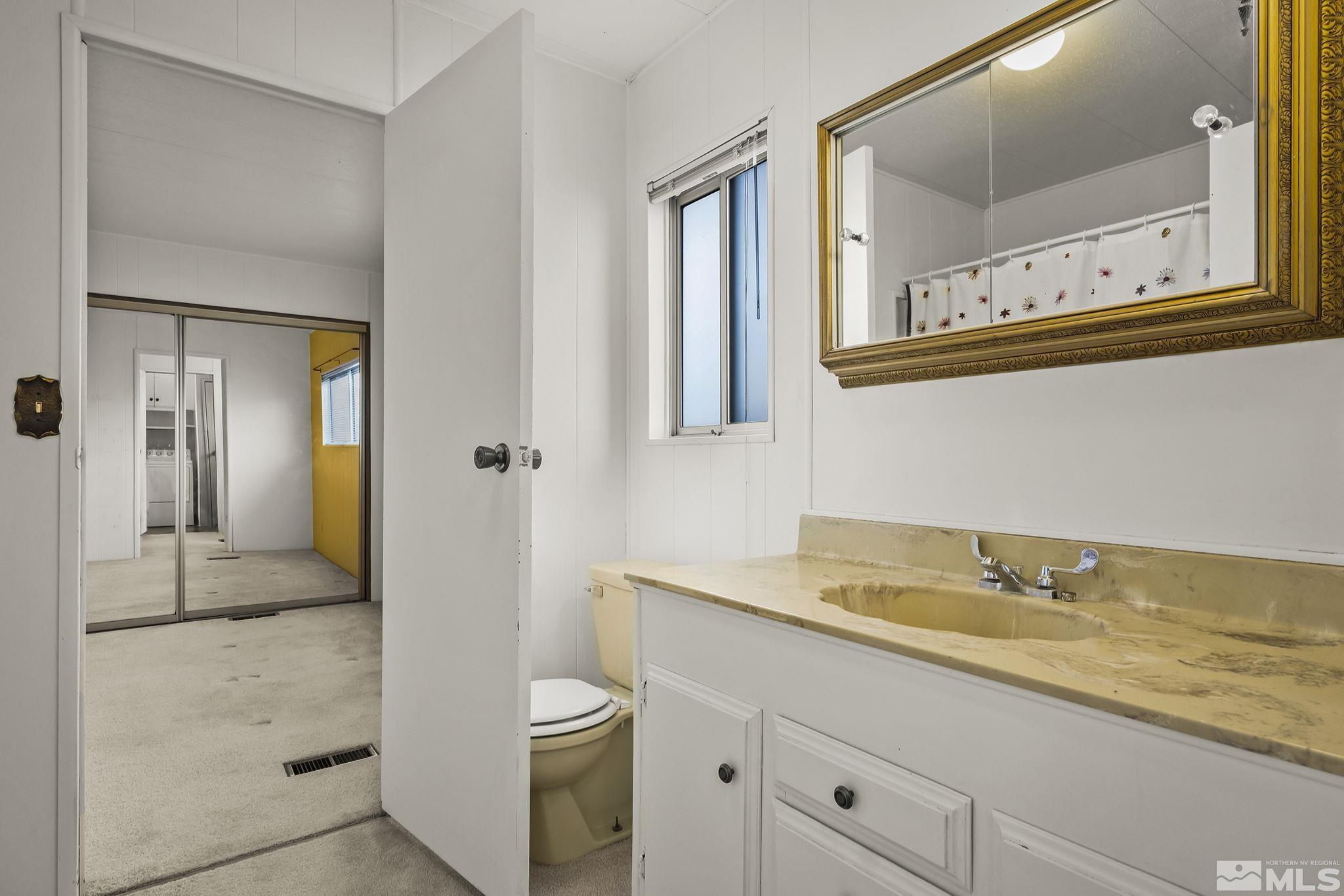 16305 Rhyolite Circle Reno, NV 89521 - Photo 15 of 16 a bathroom with a sink and a mirror