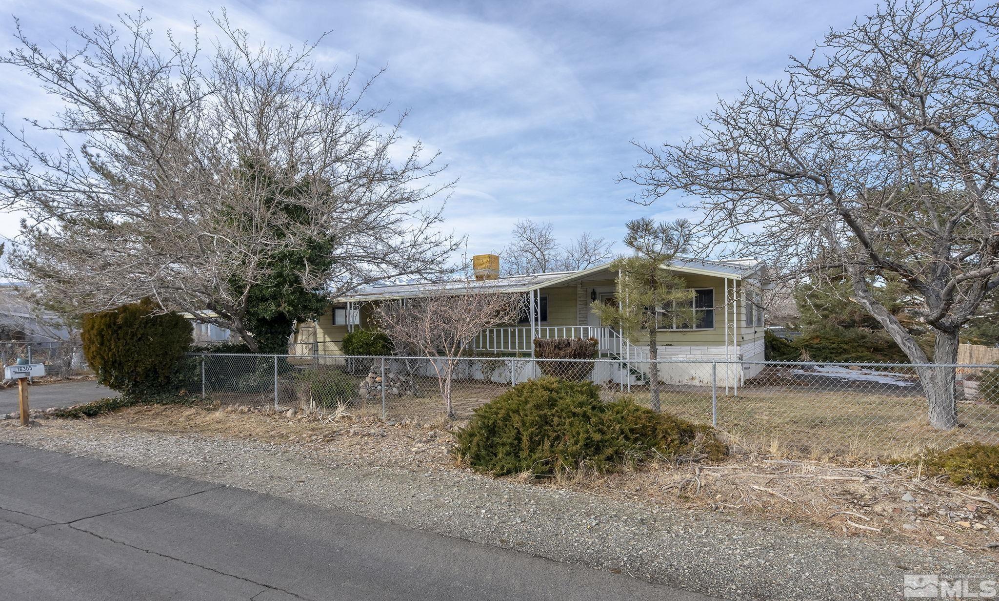16305 Rhyolite Circle Reno, NV 89521 - Photo 2 of 16 a backyard of a house with table and chairs