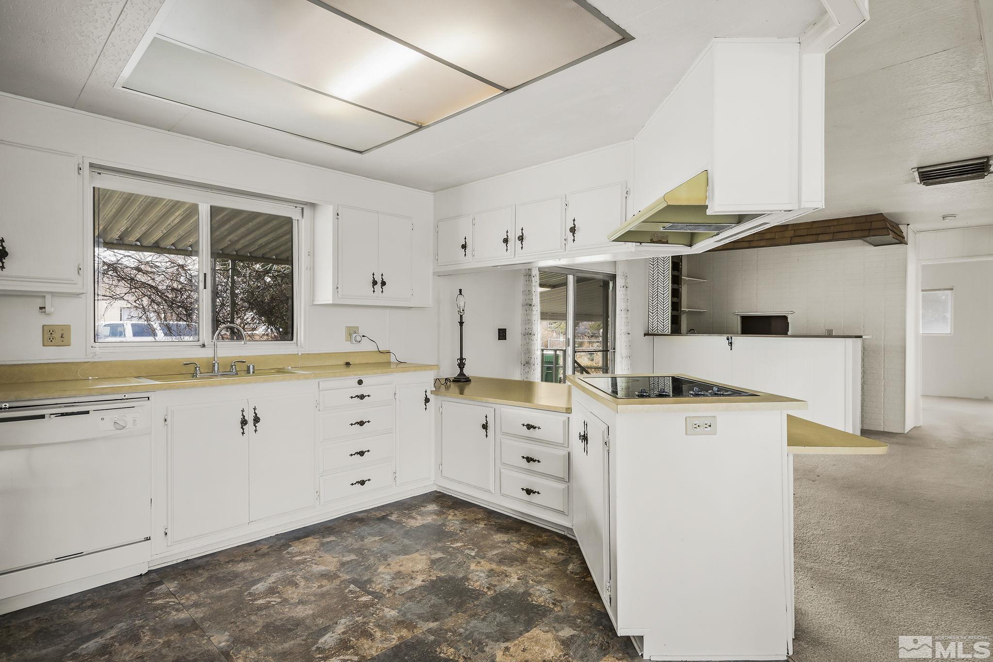 16305 Rhyolite Circle Reno, NV 89521 - Photo 7 of 16 a kitchen with cabinets appliances a sink and a window