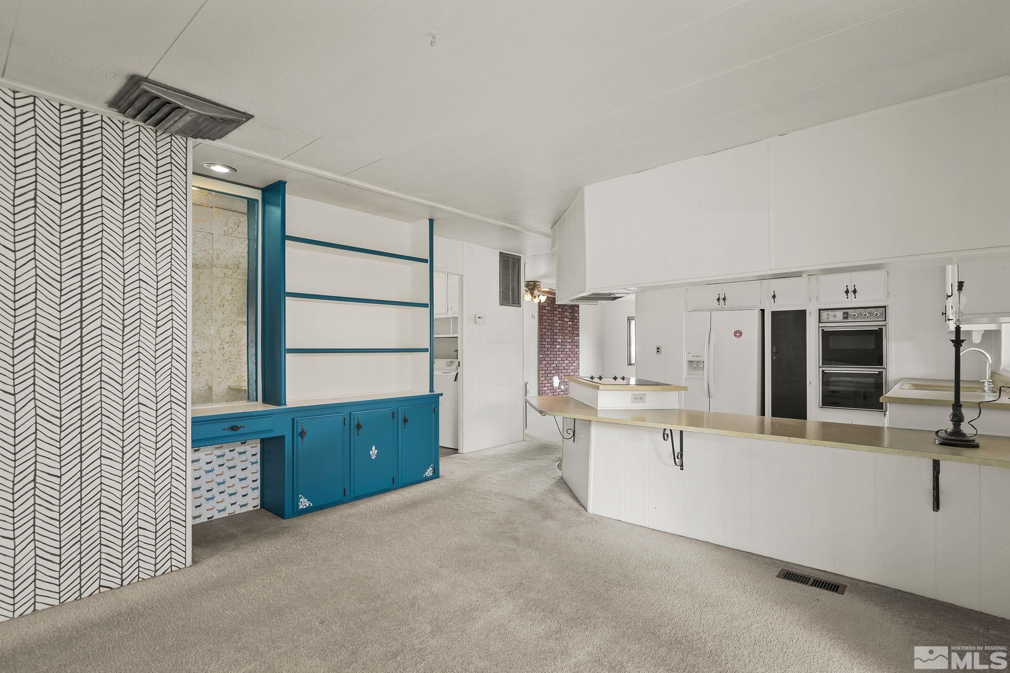 16305 Rhyolite Circle Reno, NV 89521 - Photo 10 of 16 a kitchen with stainless steel appliances cabinets and wooden floor