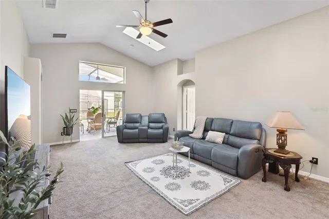 a living room with furniture a rug and a chandelier