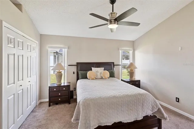 a bedroom with a large bed and a chandelier