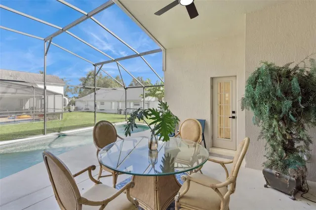 a backyard of a house with table and chairs
