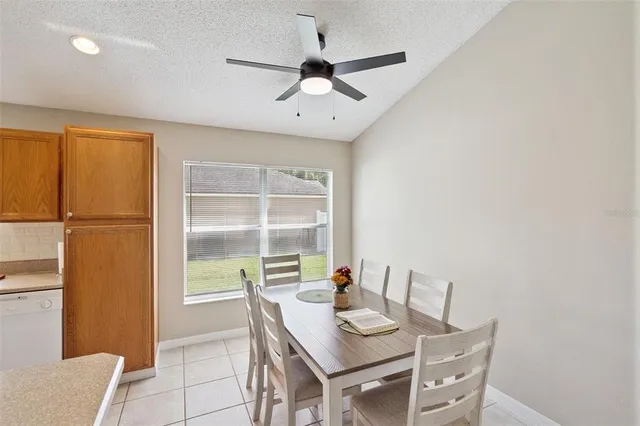 a view of a dining room with furniture and a window