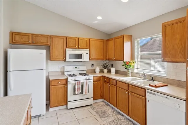 a kitchen with a sink appliances and cabinets