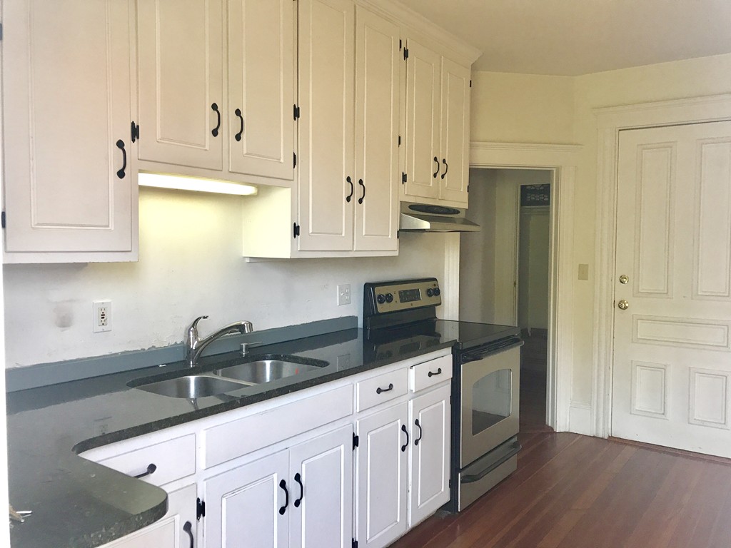 27-29 Topsfield Road, Unit 4 Ipswich, MA 01938 - Photo 5 of 22 a kitchen with stainless steel appliances granite countertop a sink a stove and a refrigerator