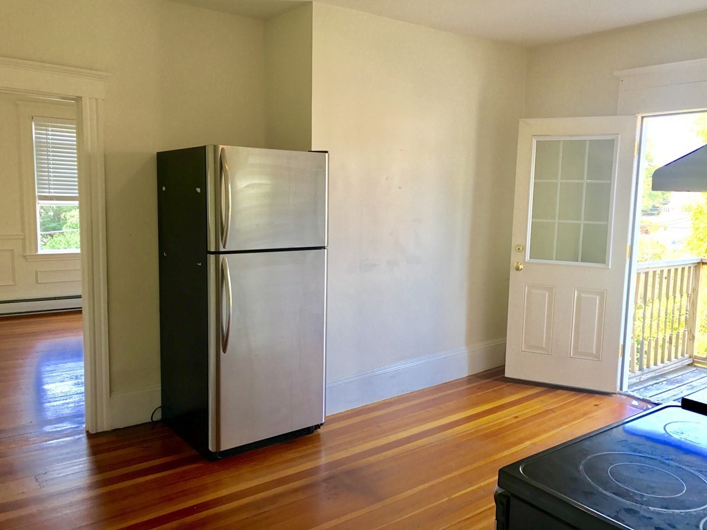 27-29 Topsfield Road, Unit 4 Ipswich, MA 01938 - Photo 7 of 22 a white refrigerator freezer sitting next to a window