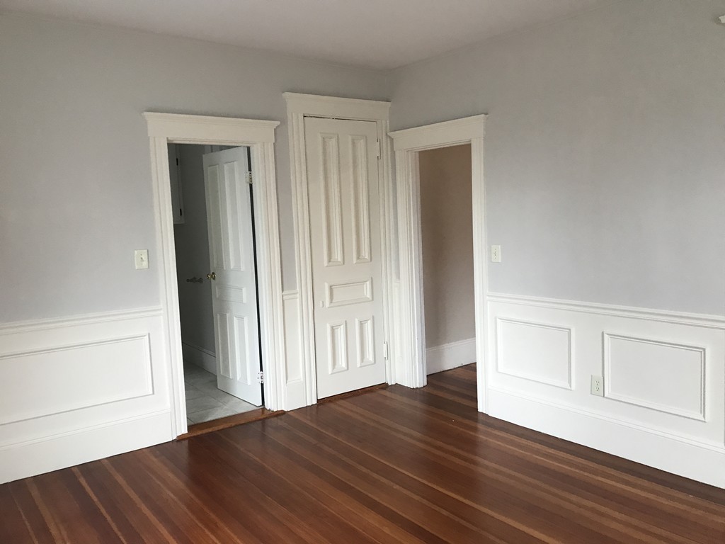 27-29 Topsfield Road, Unit 4 Ipswich, MA 01938 - Photo 9 of 22 a view of an empty room with wooden floor and closet