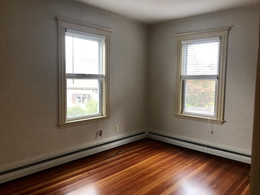 27-29 Topsfield Road, Unit 4 Ipswich, MA 01938 - Photo 10 of 22 an empty room with wooden floor and windows