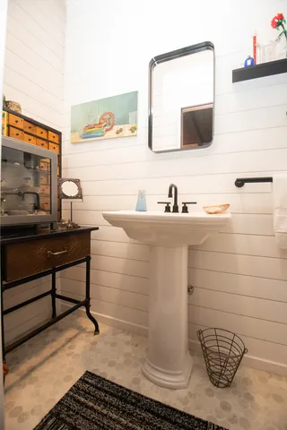 a bathroom with a sink a toilet and mirror