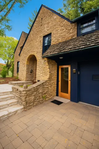 a view of a livingroom with wooden floor and a bathroom