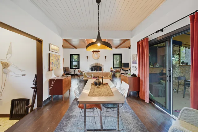 a living room with furniture a fireplace and a chandelier