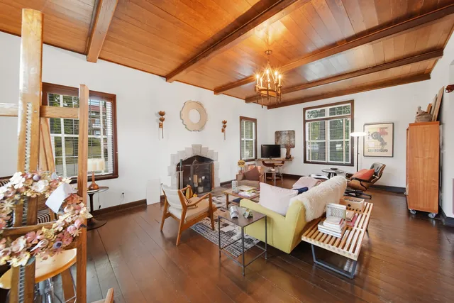 a living room with furniture a window and gym equipment