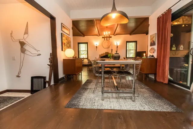 a bedroom with furniture and a large window