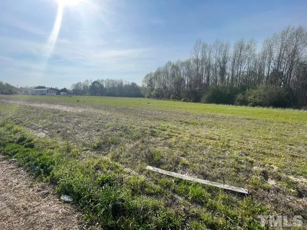 a view of a field with an ocean view