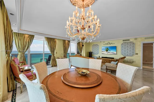 a dining room with furniture a chandelier and window