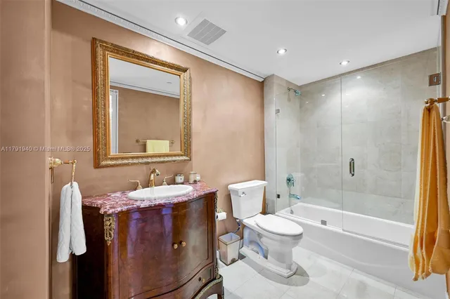 a bathroom with a bathtub shower sink mirror and toilet