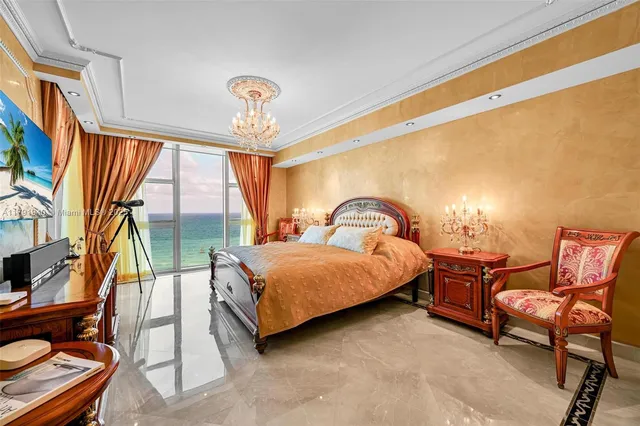 a bedroom with a bed chair and window