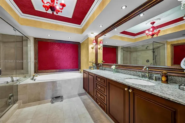 a bathroom with a granite countertop sink and large mirror