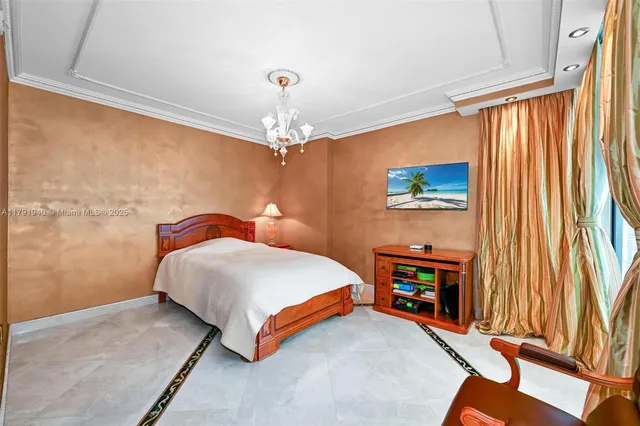 a bedroom with a bed and a chandelier