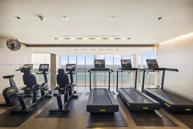 a room with gym equipment and a large window