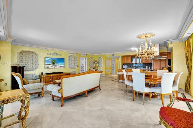 a living room with furniture and a chandelier