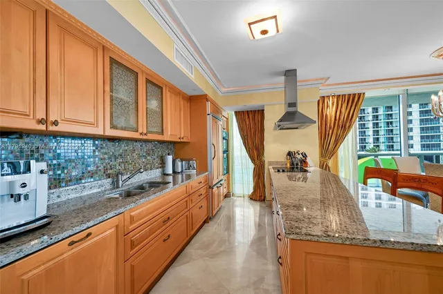 a kitchen with stainless steel appliances granite countertop a sink and a wooden cabinets
