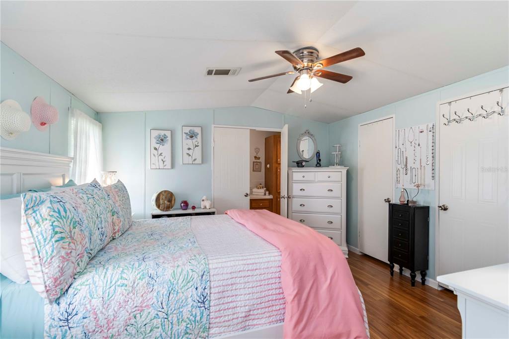 10303 Burnt Store Road, Unit 230 Punta Gorda, FL 33950 - Photo 12 of 27 a bedroom with a bed and a chandelier