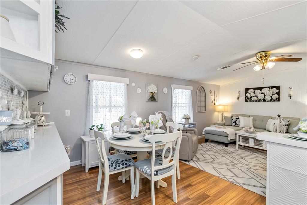 10303 Burnt Store Road, Unit 230 Punta Gorda, FL 33950 - Photo 5 of 27 a view of a dining room with furniture and wooden floor
