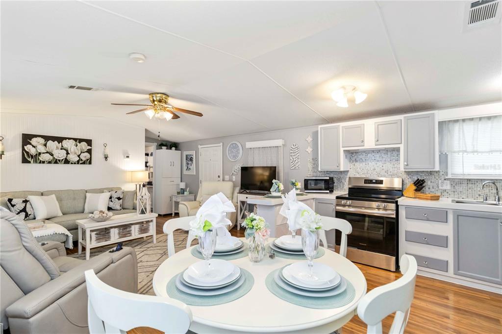 10303 Burnt Store Road, Unit 230 Punta Gorda, FL 33950 - Photo 7 of 27 a kitchen with stainless steel appliances a dining table and chairs