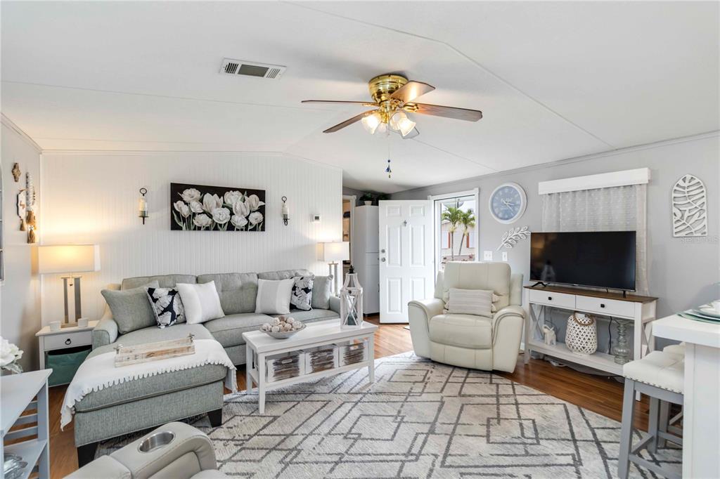 10303 Burnt Store Road, Unit 230 Punta Gorda, FL 33950 - Photo 9 of 27 a living room with furniture and a flat screen tv
