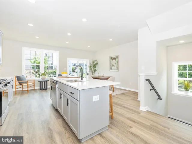 a kitchen with stainless steel appliances kitchen island granite countertop a sink and cabinets