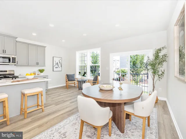 a living room with furniture kitchen view and a dining table