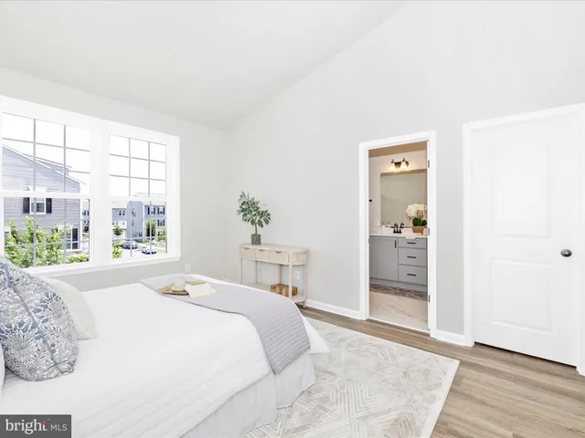 a bedroom with a bed and a night stand