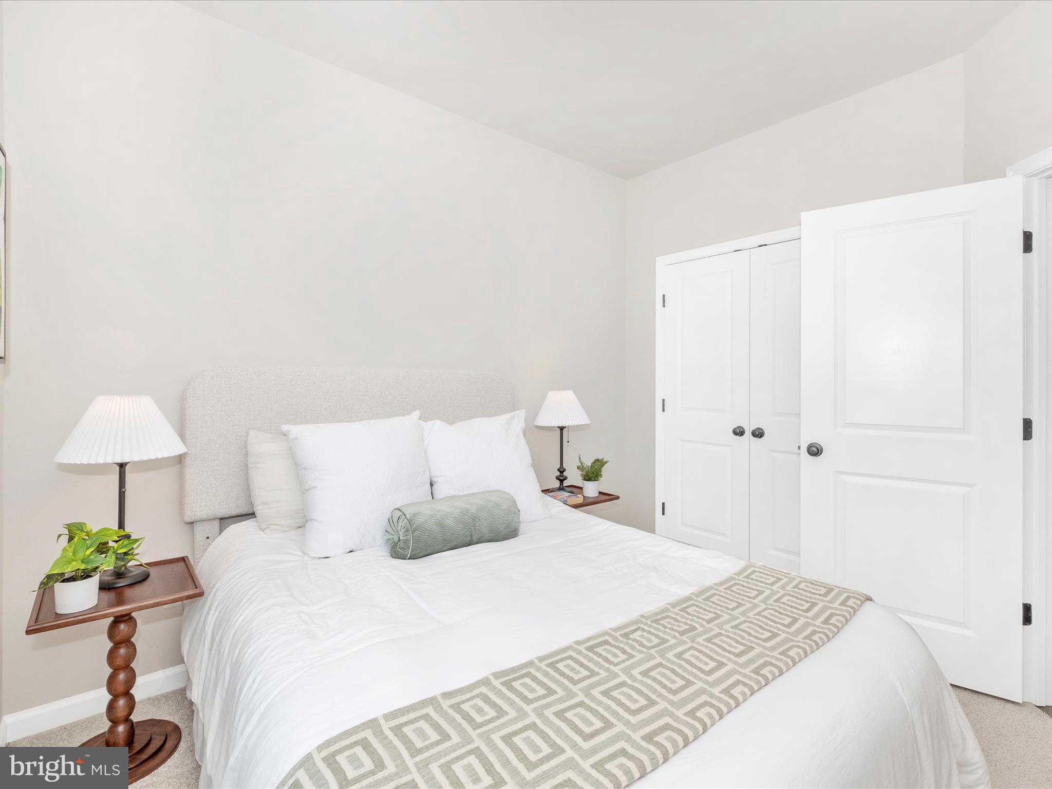 100 Spring Bank Way Frederick, MD 21701 - Photo 35 of 43 a bedroom with a bed and a lamp