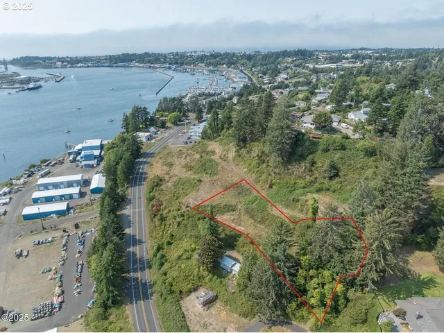an aerial view of beach and residential houses with outdoor space