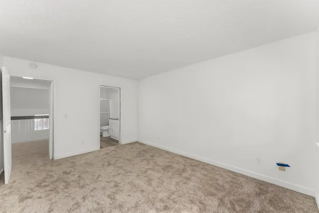 a view of an empty room and closet area