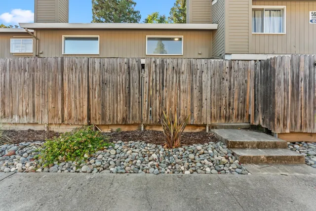 a view of backyard with swimming pool and outdoor seating
