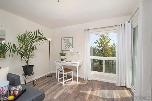 a view of a livingroom with furniture and a window